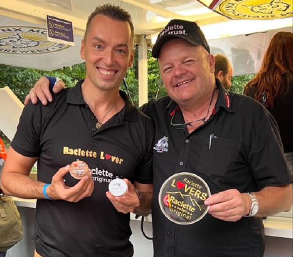 Milan Kolář with a friend and Raclette Lovers stickers at a festival